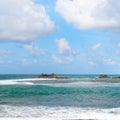 Tropical sandy beach and turquoise clear ocean water - summer vacation natural background with blue sunny sky Royalty Free Stock Photo