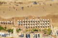 Tropical sandy beach with white umbrellas, aerial top view from drone Royalty Free Stock Photo