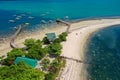 Tropical sea coast-Islands with white sand, local huts, palm trees. Aerial view from the drone