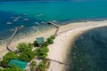 Tropical sea coast-Islands with white sand, local huts, palm trees. Aerial view from the drone