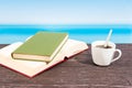 Tropical sea seen from the boat. Book and coffee on table. Reading and relaxing on vacation Royalty Free Stock Photo