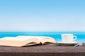 Tropical sea seen from the boat.  Book and coffee on table. Reading and relaxing on vacation Royalty Free Stock Photo