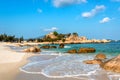 Tropical Seascape with White Sandy Beach, Waves, Rocks, Clouds and Sky