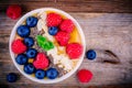 Tropical smoothie bowl with raspberries, blueberries, chia seeds and almonds Royalty Free Stock Photo