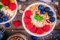 Tropical smoothie bowl with raspberries, blueberries, granola and coconut Royalty Free Stock Photo