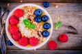 Tropical smoothie bowl with raspberries, blueberries, granola and coconut Royalty Free Stock Photo