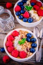 Tropical smoothie bowls with raspberries, blueberries, chia seeds and granola Royalty Free Stock Photo