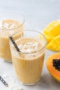 Tropical smoothie of mango, coconut and papaya Royalty Free Stock Photo