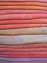 Stack of wool fabrics detail in orange pink purple violet Royalty Free Stock Photo