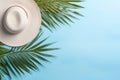 Tropical Summer Composition with Palm Leaves, Hat, and Coconut on Pastel Blue Background AI Generated Royalty Free Stock Photo