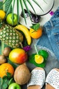 Tropical Summer Fruits Glass of Fresh Juice Pineapple Mango Bananas Coconut on Large Palm Leaf. Women Jeans Shorts Slippers Hat Royalty Free Stock Photo