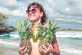 Tropical summer woman with pineapple. Outdoors, ocean, nature. Bali island paradise.