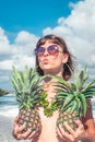 Tropical summer woman with pineapple. Outdoors, ocean, nature. Bali island paradise.