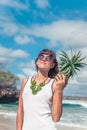 Tropical summer woman with pineapple. Outdoors, ocean, nature. Bali island paradise, Indonesia.