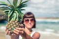 Tropical summer woman with pineapple. Outdoors, ocean, nature. Bali island paradise, Indonesia.