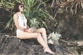 Tropical summer woman with pineapple. Outdoors, ocean, nature. Bali island paradise. Indonesia.