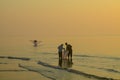 Tropical sunrise seascape with men hand net fishing, Thailand