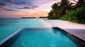 Luxury Infinity Pool Overlooking Tropical Sunset Beach with Overwater Bungalows Royalty Free Stock Photo