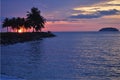 Tropical sunset over ocean and island