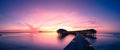 Tropical sunset panorama. Beach sunset in Maldives island with luxury water villas and long wooden pier