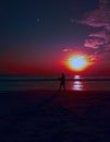 Tropical sunset, quiet, warm evening, people silhouettes Royalty Free Stock Photo