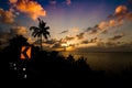 Tropical sunset by the sea with plam or coconut tree silhouette Royalty Free Stock Photo