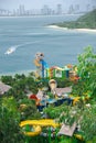 Tropical themed water park with downtown Nha Trang skylines mountain range background, aerial view colorful family aquapark, long