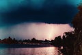 A tropical thunder storm over a country town with lightning strike