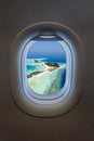 View from an airplane window to a tropical paradise island in the Maldives Royalty Free Stock Photo