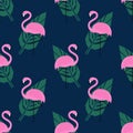 Tropical trendy seamless pattern with pink flamingos and green palm leaves on dark blue background. Royalty Free Stock Photo