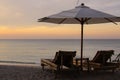 Tropical umbrella and bamboo long chairs on beach