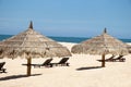 Tropical view of a beach with umbrellas and beach chairs