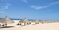 Tropical view of a beach with umbrellas and beach chairs