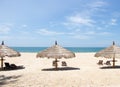 Tropical view of a beach with umbrellas and beach chairs