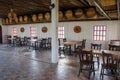 Tropical view in restaurant, Many group of wooden tables and chairs with wine barrels decorate in the room. Royalty Free Stock Photo