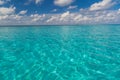Crystal clear tropical sea water and blue sky. White sandy tropical beach background Royalty Free Stock Photo