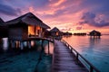 tropical water home villas resort at Maldives island at summer vacation, Water villas on Maldives resort island in sunset, AI Royalty Free Stock Photo