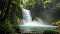 Tropical Waterfall Cascading Into Turquoise Pool Surrounded by Lush Greenery Royalty Free Stock Photo