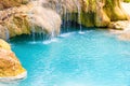 Tropical waterfall with emerald blue lake and rocks in jungle forest Royalty Free Stock Photo