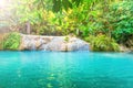 Tropical waterfall with emerald lake in jungle forest Royalty Free Stock Photo