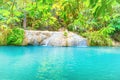 Tropical waterfall with emerald lake in jungle forest Royalty Free Stock Photo