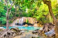Tropical waterfall with emerald lake and rocks in jungle forest Royalty Free Stock Photo