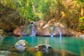 Tropical waterfall with emerald lake and rocks in jungle forest Royalty Free Stock Photo