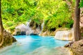 Tropical waterfall with emerald lake and rocks in jungle forest Royalty Free Stock Photo