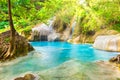 Tropical waterfall with emerald lake and rocks in jungle forest Royalty Free Stock Photo