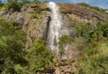 Tropical waterfall falls from the mountain cliff to the jungle, serene landscape of Diyaluma falls