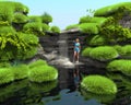 Tropical waterfall on the lake. Girl in a blue bathing suit