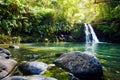 Tropical waterfall Lower Waikamoi Falls and a small crystal clear pond, inside of a dense tropical rainforest, off the Road to Han