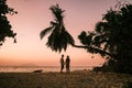 Tropical white beach at Praslin island Seychelles, happy Young couple man and woman during vacation Holiday at the beach Royalty Free Stock Photo