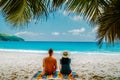Tropical white beach at Praslin island Seychelles, happy Young couple man and woman during vacation Holiday at the beach Royalty Free Stock Photo